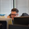 Man talking on phone at his desk