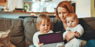 Photo of a woman sitting on a couch with two children